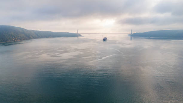Aerial view of cargo container ship in transit in Istanbul Bosphorus. Aerial view of freight ship with cargo containers. Container ship is crossing the Bosporus in Istanbul, Turkey.