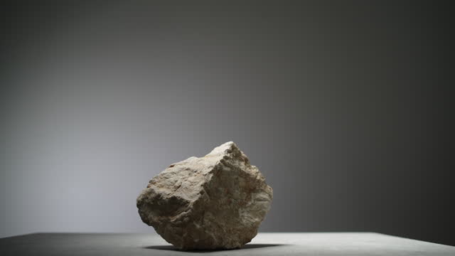 A stone with rough edges under studio lights