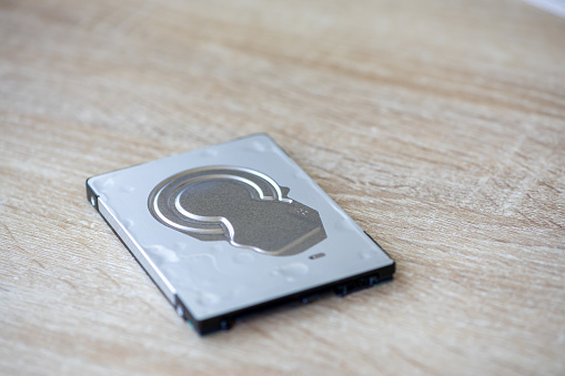 Close-up of a hard disk isolated on a table. Front view.
