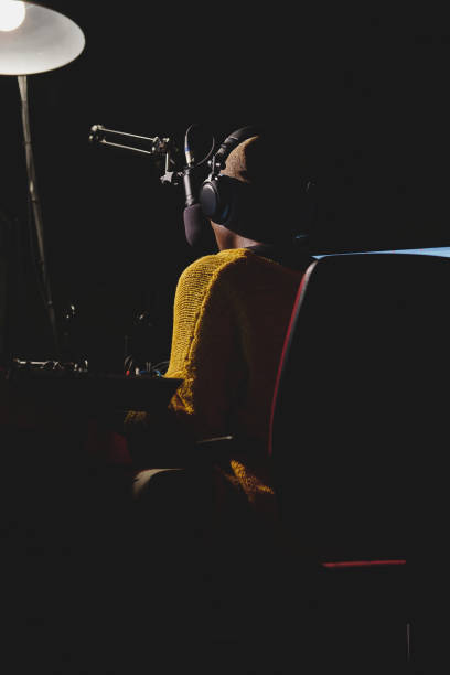 istock Unrecognizable ethnic woman in headset in dark broadcast studio 2149156596