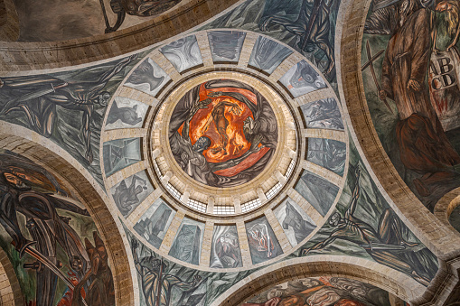 Guadalajara, Mexico - 10-07-2023: Gazing Upon the Magnificent Mural in the dome inside the Hospicio Cabanas building.