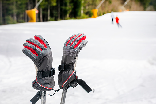 ski gloves dressed on ski poles on the slope. Leisure