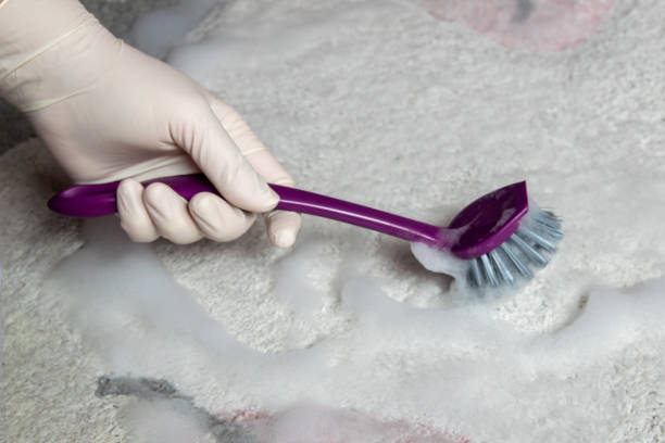 istock Blue brush on the floor with hand in rubber glove. Cleaning. 2149159821