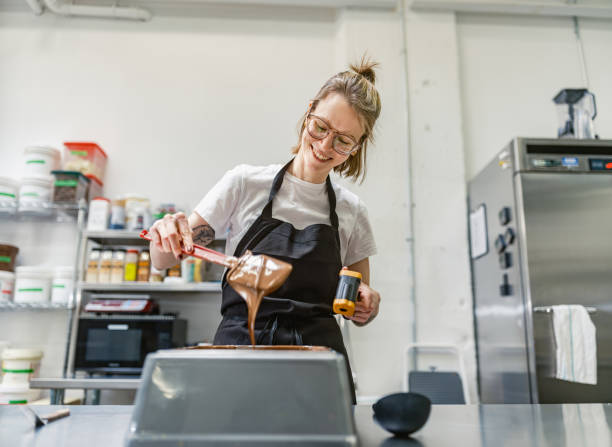 istock One female chocolatier working at the chocolate factory 2149161008