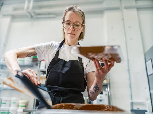 istock One female chocolatier working at the chocolate factory 2149161550