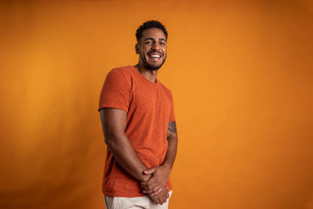 istock Portrait of a young man on a orange background 2149162837