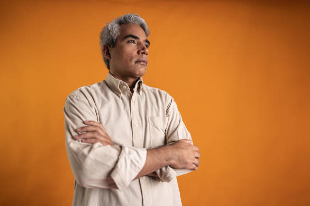 istock Mature man looking away on a orange background 2149162872