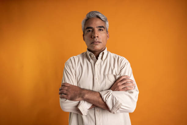 istock Portrait of a mature man on a orange background 2149162876