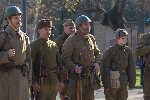 Vorzel, Ukraine - November 03, 2019: People in the form of Red Army soldiers stand in formation with weapons on the historical reconstruction of the anniversary of the victory in World War II