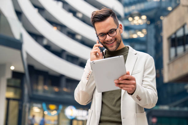 istock Smiling confident business man freelancer running his own business using digital tablet 2149164237
