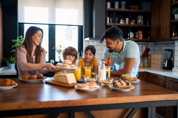 istock Proud happy parents having breakfast with children 2149164652