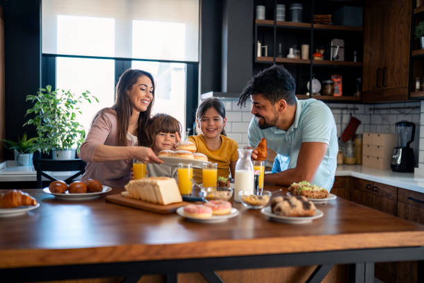 istock Proud happy parents having breakfast with children 2149164663