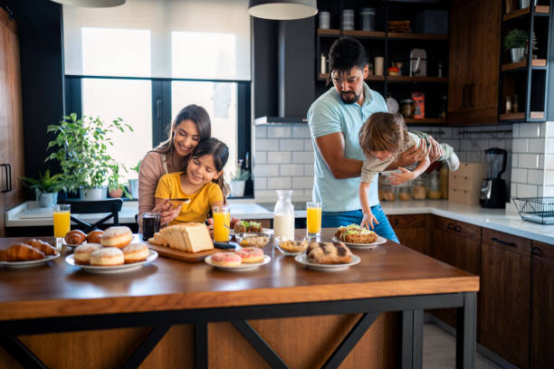 istock Young parents with small children having fun during breakfast 2149164739