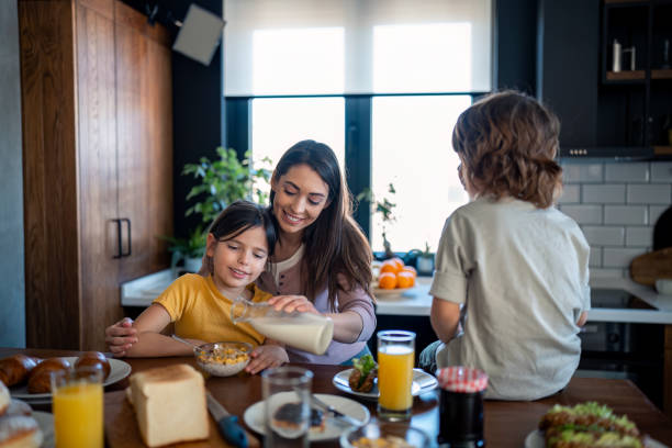 istock Happy kids enjoying delicious breakfast with mom 2149164935