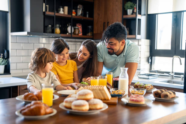 istock Children having breakfast with parents in home atmosphere. 2149165306
