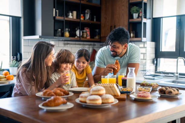 istock Happy family having breakfast at home 2149165476