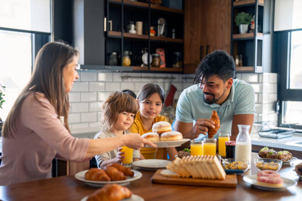 istock Happy parents having breakfast with children 2149165559