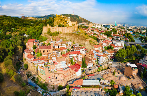 Abanotubani ancient district and Narikala fortress aerial panoramic view in Tbilisi old town. Tbilisi is the capital and the largest city of Georgia on the banks of the Kura River.