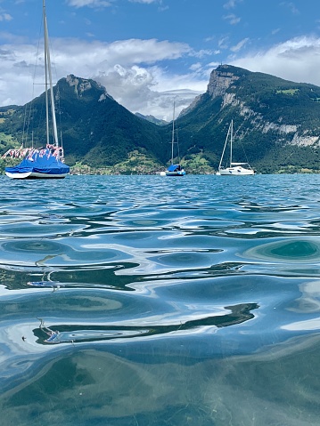 Closeup of water , boats and mountains in lake Thun Swizerland