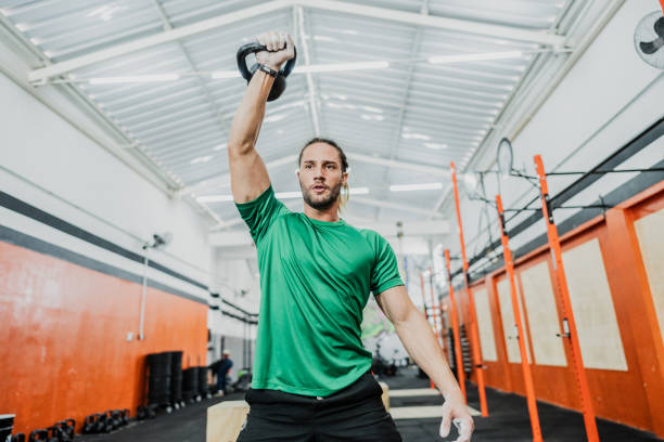 istock Young man exercising with kettlebell at gym 2149170234