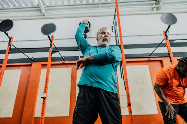 istock Senior man exercising with kettlebell at gym 2149170240