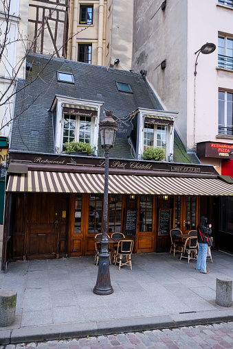 Paris, France - 20.02.2024. Typical French restaurant named Le petit Chatelet near Notre Dame Cathedral in Paris. Located at Square Pierre-Gilles de Gennes at 39 Rue de la Bûcherie. Charming and restaurant in Paris downtown