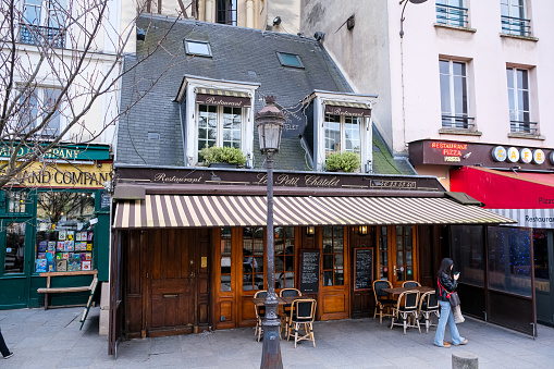 Paris, France - 20.02.2024. Typical French restaurant named Le petit Chatelet near Notre Dame Cathedral in Paris. Located at Square Pierre-Gilles de Gennes at 39 Rue de la Bûcherie. Charming and restaurant in Paris downtown