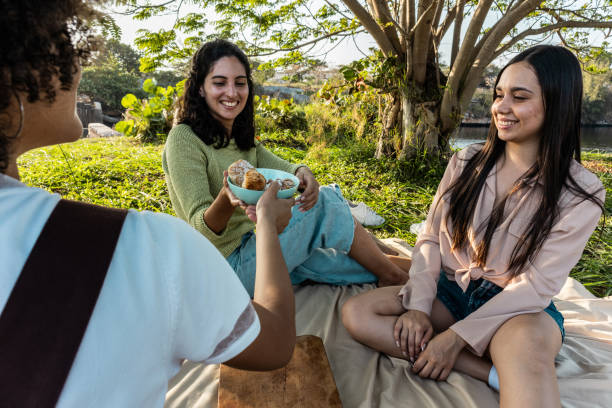 istock Young women doing a picnic outdoors 2149171169