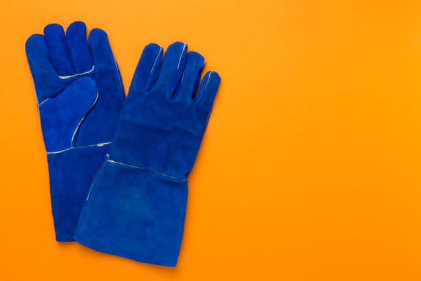 istock Blue construction gloves on color background, top view 2149173685