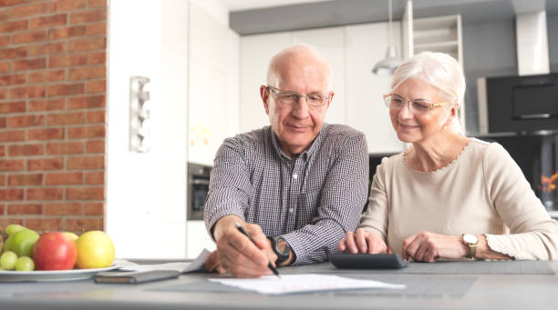 istock Senior couple doing bill calculations at home 2149174728