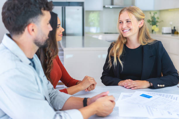 istock Real Estate or Insurance agent with couple looking through documents. 2149176174
