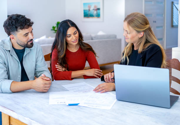 istock Real Estate or Insurance agent with couple looking through documents 2149176209