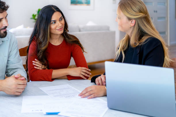 istock Real Estate or Insurance agent with couple looking through documents. 2149176243