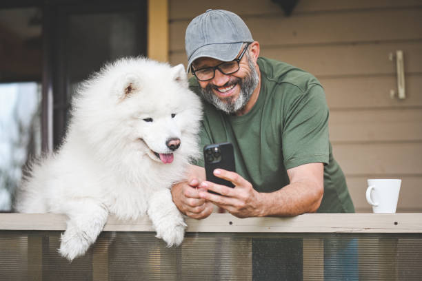 istock mature adult man with samoyed dog 2149176659