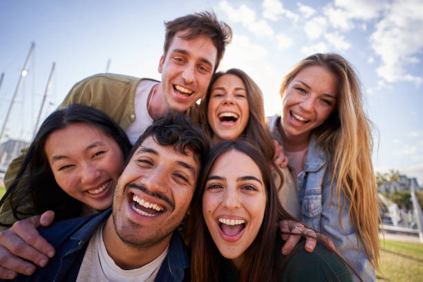 istock Portrait group diverse young happy people looking excited at camera having fun together outdoor. 2149176687