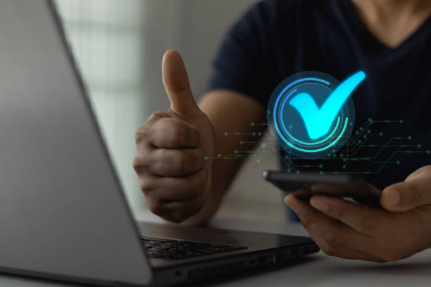 istock Businessman showing ok, hand with thumb up. Mobile payment is accepted. Quality control, online marketing, quality assurance, business finance guarantee, cybersecurity, digital technology concept. 2149176688