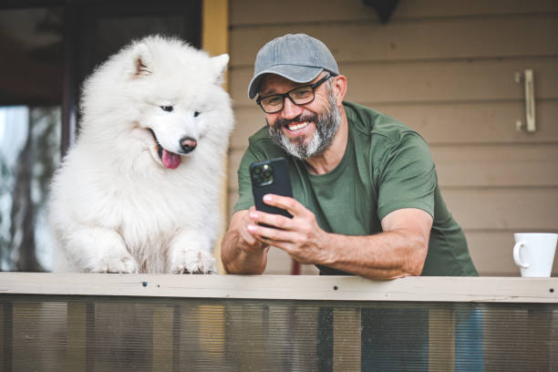 istock mature adult man with samoyed dog 2149176762