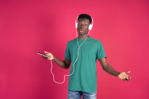 istock Man Wearing Headphones Holding Cell Phone 2149176794