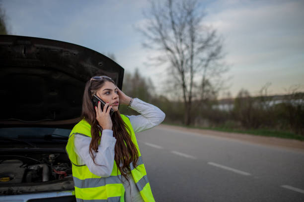 istock Young stressed woman standing next to her broke down car and using her phone to call for help 2149178012