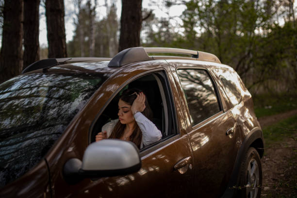 istock Young bored woman sitting in car and waiting for help 2149178123