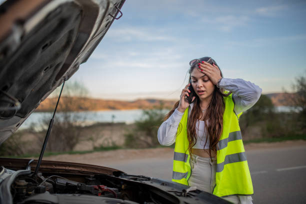 istock Young stressed woman standing next to her broke down car and using her phone to call for help 2149178136