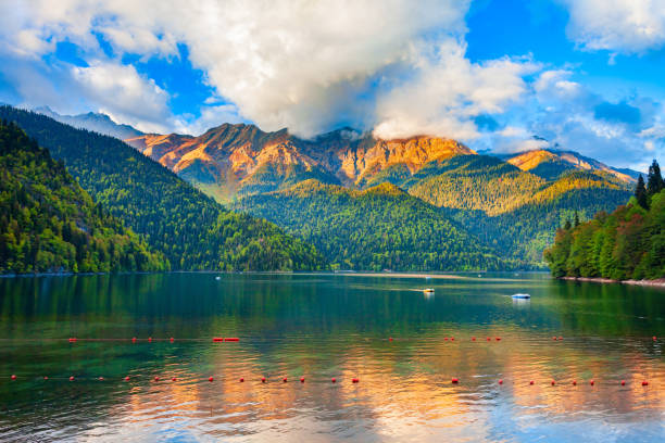 Lake Ritsa panoramic view, Abkhazia Lake Ritsa panoramic view at sunset. Lake Ritsa is a lake in the Caucasus Mountains in Abkhazia region, Georgia. caucasus stock pictures, royalty-free photos & images