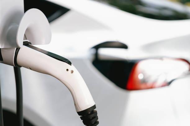 istock Closeup EV plug charger attached to EV car for battery recharging. Exalt 2149178546