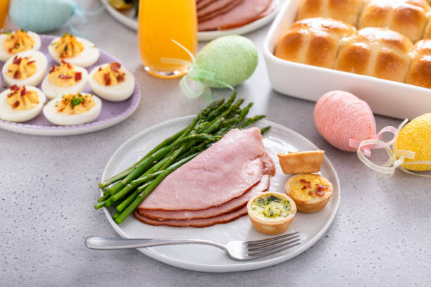 istock Easter brunch table with a potion of ham with asparagus on the plate 2149179068