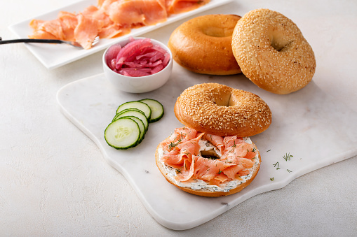 Bagels served with cream cheese, smoked salmon and fresh cucumber, sesame lox bagels
