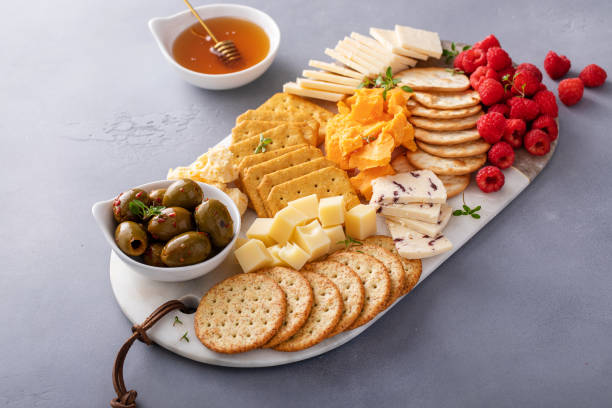 istock Small cheese and cracker board with fresh berries and olives 2149179114
