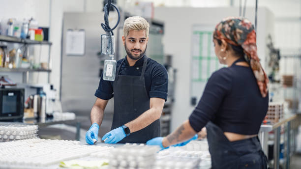 istock Two chocolatiers working at the chocolate factory 2149180087
