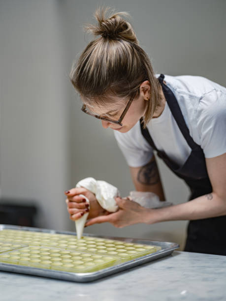 istock One female chocolatier working at the chocolate factory 2149180110