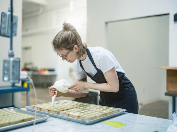 istock One female chocolatier working at the chocolate factory 2149180119