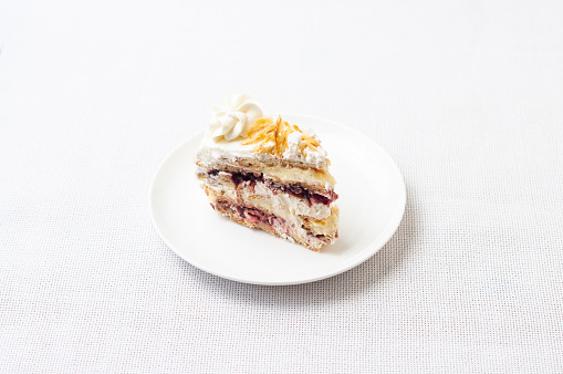 Delicious piece of cream cake, delicacy, jam with puff pastry